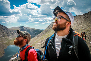  Two people hiking while using Noz Nose Sunscreen.